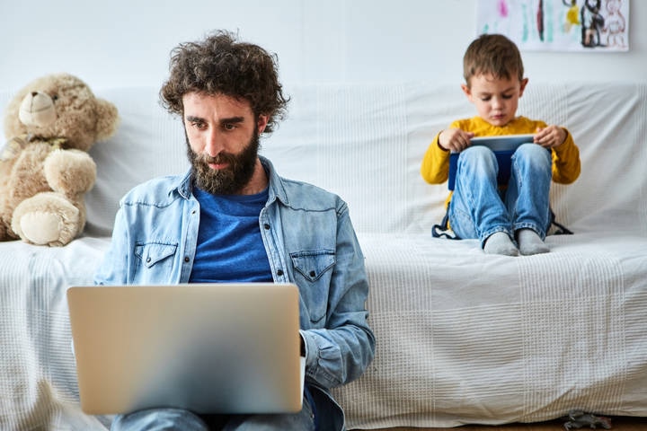 Adult and child looking at devices