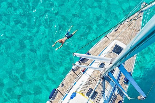 Image of Yacht floating on clear blue water